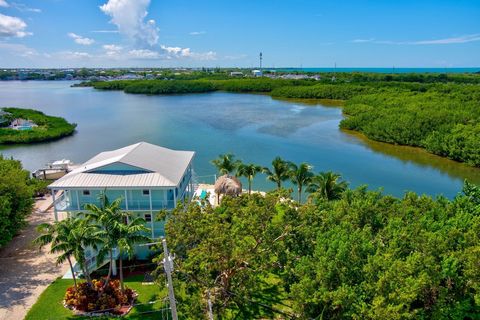 Endless Sunset Views over an extra-wide deep draft lagoon, with enviable no-bridge access to the Atlantic Ocean, this stunning waterfront estate in desirable Coco Plum Beach has it all! Nestled on nearly half an acre, with 300' of waterfront, 4-post ...