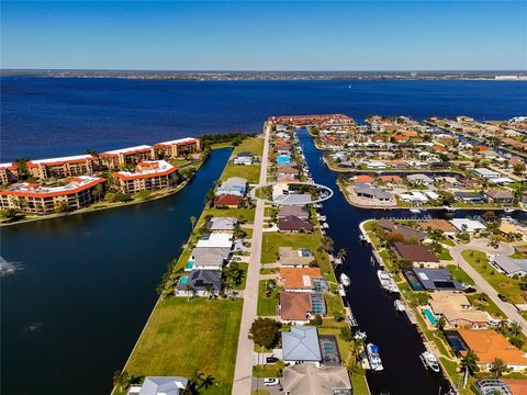 Nestled in the prestigious sailboat section of Punta Gorda Isles, with no bridges to navigate, this exquisite home promises an unmatched waterfront lifestyle. Just 3 minutes from the Harbor, it features a newly rebuilt 20,000-pound boatlift (2022/23)...