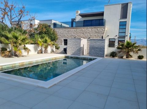 A beautiful contemporary villa with a swimming pool for sale in a quiet place near Zadar with a sea view! Villa is located just 120 meters from the sea! The villa of 364 m2 is spread over 675 m2 of land and has two floors, ground floor and first floo...