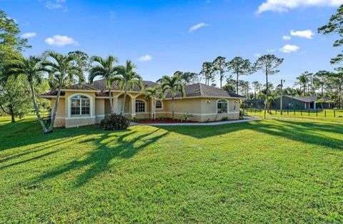 Lovely corner lot house with 3 bedroom, 2 bathroom on 1.42 acres of land located in Loxahatchee/The Acreage, Florida in Palm Beach County. Split floor plan with vaulted ceilings and hurricane impact windows and patio doors throughout. Renovated kitch...
