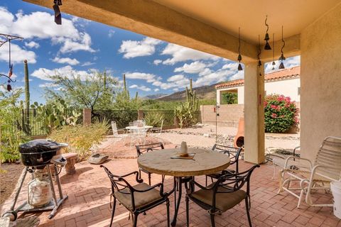Fabulous views of mountains and city lights. Nestled in the foothills of the Catalina mountains in the secure guard gated community of Sabino Springs and Arizona National Golf. This impeccably maintained 4 bedroom/ 2 bath is perfect for year round li...