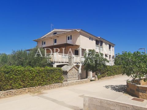 For sale HOUSE with 4 apartments 50 m away from the sea in Povljana on the island of Pag. The property consists of a basement, ground floor, 1st and 2nd floor. It also has a spacious infield with 12 parking spaces. PROPERTY DESCRIPTION: BASEMENT - ap...