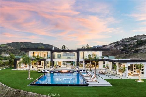 Experience the perfect blend of breathtaking panoramic views and serene privacy in this exquisite home, perched high in the sky over Malibu and nestled amongst the clouds - a true dream retreat. This stunning Malibu estate is a true masterpiece of ar...