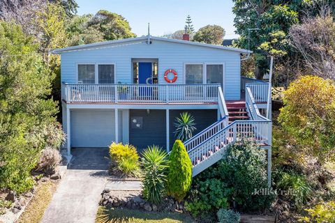 This timeless beach house, a five-minute stroll from the bay and village is location perfect. Set well back from the street, behind mature flora and a sprawling lawn, the elevated property with its flowing layout, wraparound balcony, expansive rear d...