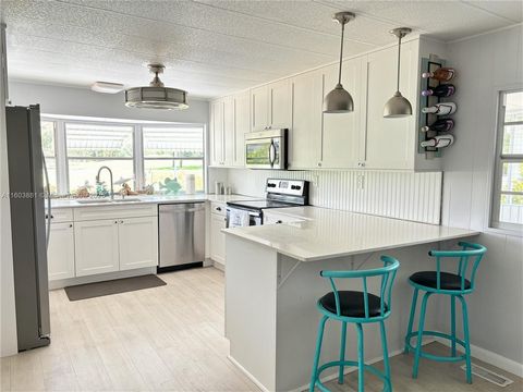 This stunning double-wide modern mobile home is located in a 55+ community where you own the land, It boasts 2 bedrooms, 2 bathrooms, and a spacious laundry room. The modern interior features an updated kitchen with a new refrigerator, stainless stee...