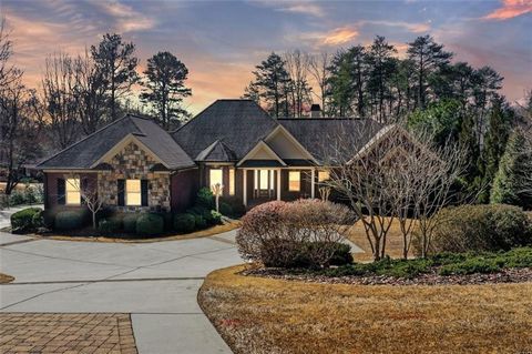 Indulge in the elegance of lakeside luxury with this awe-inspiring custom home, boasting exclusive access to the serene waters of Lake Lanier. As you embark on a tour of this residence, you'll be captivated from the outset by its grandeur - a stately...