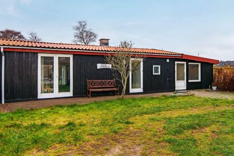 Close to the bathing beach in Høll, this holiday home is located in a child-friendly area with a good lawn. The house is well furnished with i.a. large activity room. From the living room there is access to the terrace where the sun can be enjoyed. N...