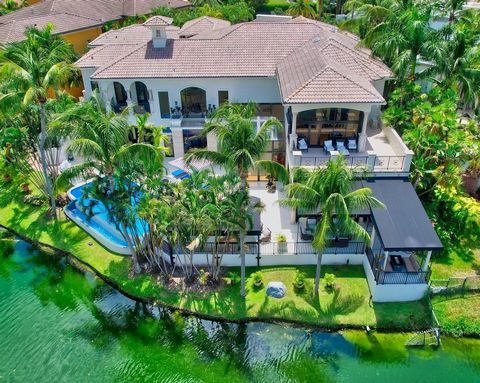 Spectacular gated mansion in Mizner Lake Estates on the grounds of the famed Boca Hotel Resort and Beach Club with the most incredible lakefront and golf course views. This one-of-a-kind masterpiece with the most stunning new outdoor patio, summer ki...