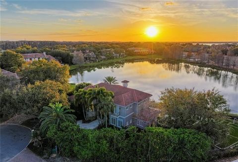 Your family simply must see this heavenly retreat! Nestled on a tranquil cul-de-sac, this Isleworth estate will steal your heart. From every corner of the house, you'll be captivated by the breathtaking views of Hourglass Pond. As you step into the l...
