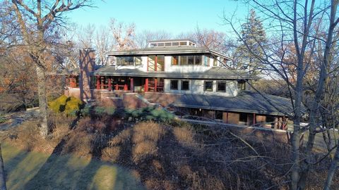 Stunning Indian Hills residence offers impeccable quality and craftmanship with style! Enjoy the timeless custom design by Rehkamp Larson architects built by Dovetail with unmatched attention to every detail. This totally private hilltop setting is e...