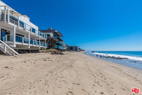 Perched along the prestigious Malibu Road, this quintessential beachfront residence offers an unparalleled blend of luxury and coastal living. Boastingbreathtaking panoramic views of the ocean and city lights, this residence exudes warmth and sophist...