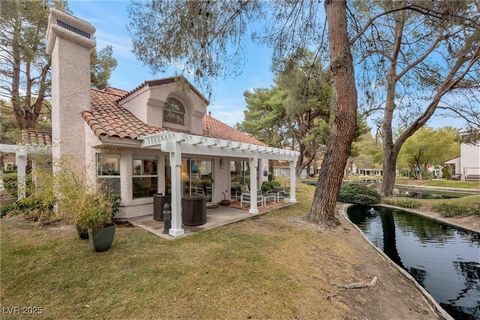 Discover a fully remodeled, warm & contemporary townhome nestled within the prestigious guard-gated Spanish Trail Country Club. This stunning home is situated on a premium lot, boasting serene waterscapes complete w/ koi fish, turtles, & ducklings. T...