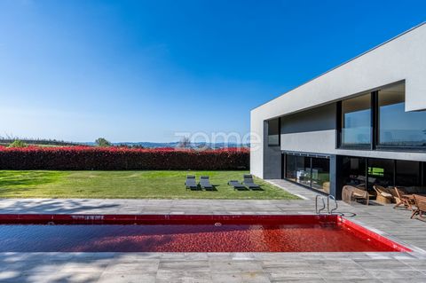 Identificação do imóvel: ZMPT564607 Discover the pinnacle of architectural elegance and harmony with nature in this stunning villa, masterfully designed by a distinguished couple of architects from Porto. Located in Burgães, Santo Tirso, this propert...